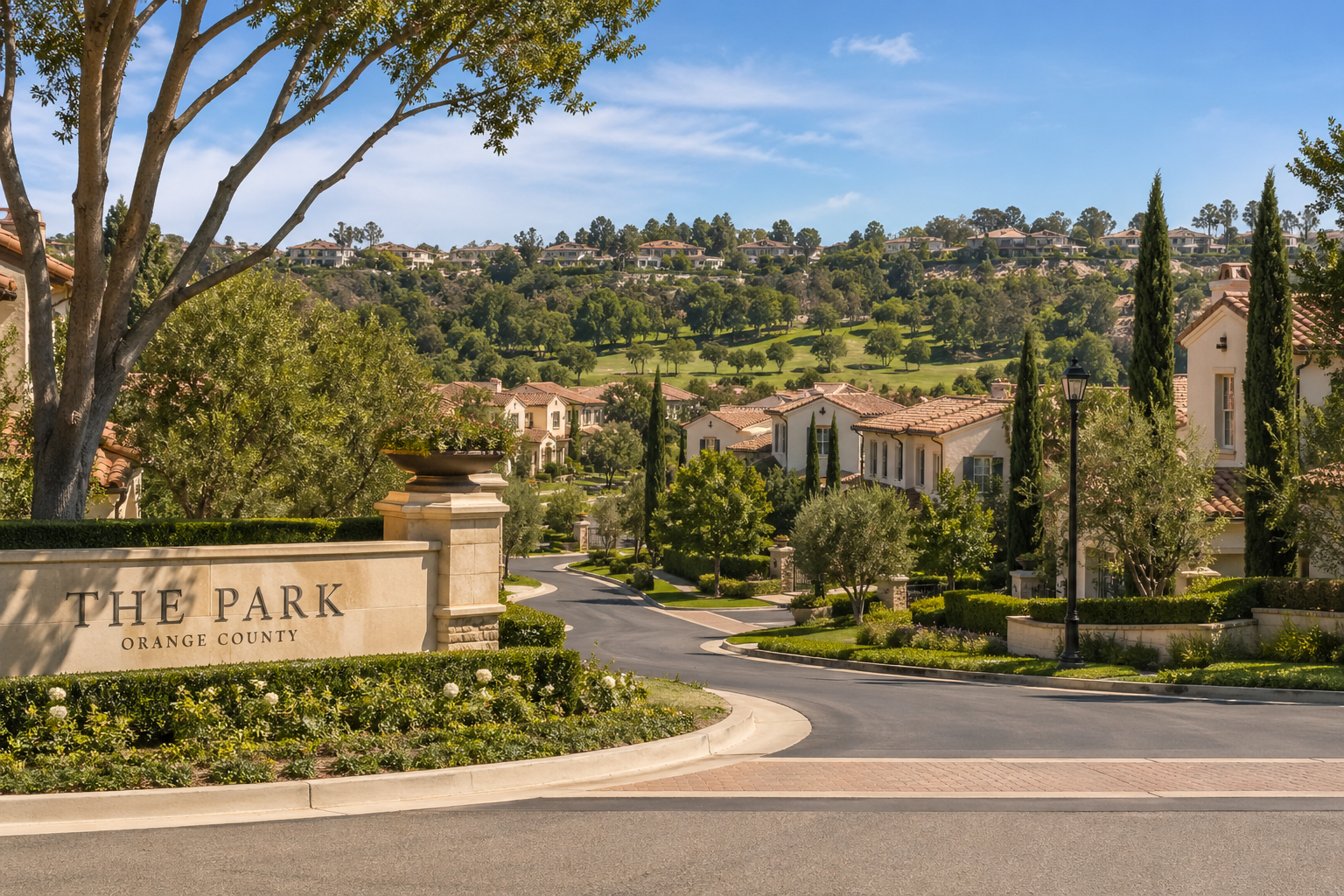 Entrance to The Park, Orange County — an upscale gated community with Mediterranean-style homes set against a wooded hillside